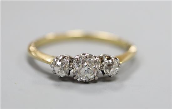 An 18ct and three stone diamond ring, size Q.
